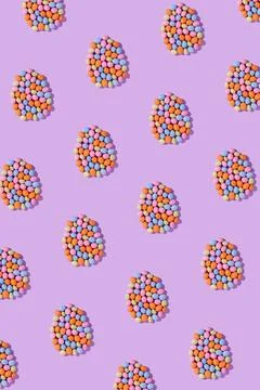 Colorful easter dragee on a violet background Stock Photos