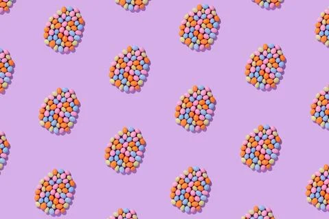 Colorful easter dragee on a violet background Stock Photos