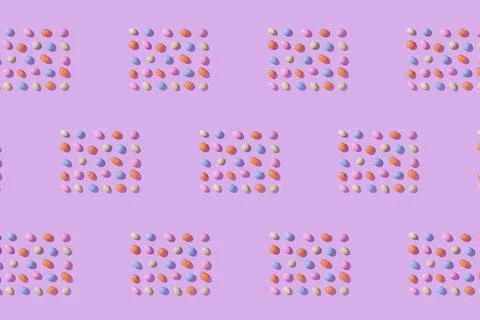 Colorful easter dragee on a violet background Stock Photos