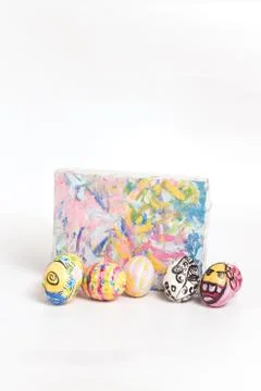 Colorful easter egg and small painted canvas on white Stock Photos