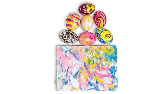 Colorful easter egg and small painted canvas on white Stock Photos