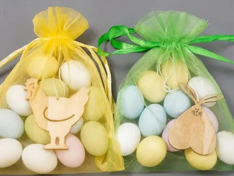 Colorful easter egg bags with bunny decorations and ribbons Stock Photos
