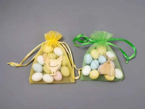 Colorful easter egg bags with plush toys and ribbons Stock Photos