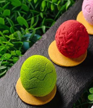 Colorful easter egg chocolate mousse desserts on slate Stock Photos