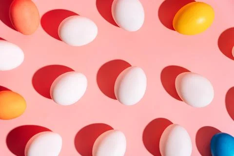 Colorful Easter egg pattern on pink background with hard shadows 스톡 사진