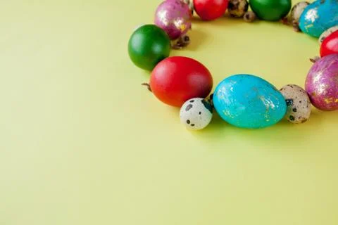 Colorful Easter egg side border over a yellow paper background Stock Photos