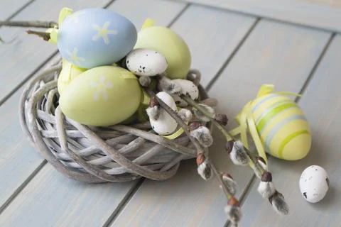 Colorful easter eggs and branch in nest close up Stock Photos