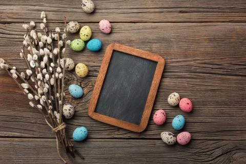 Colorful easter eggs and brushes on wooden table. Top view with copy space Stock Photos
