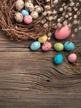 Colorful easter eggs and brushes on wooden table. Top view with copy space Stock Photos