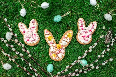 Colorful easter eggs and bunny decorations on green grass Stock Photos
