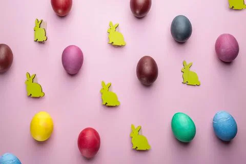 Colorful easter eggs and bunny decorations on pink background Stock Photos