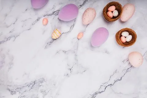 Colorful Easter Eggs and Nests on Marble Table Fotos de archivo