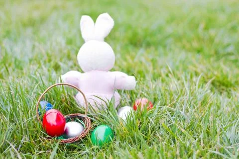 Colorful easter eggs and rabbit on green grass Stock Photos