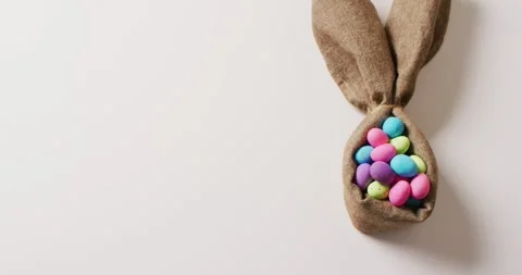 Colorful easter eggs and ribbon in shape of rabbit on white background with copy Stock Footage 331208143