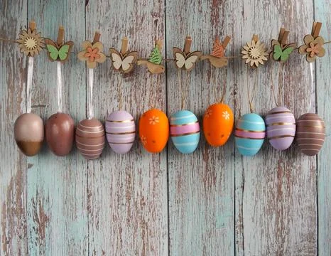 Colorful Easter eggs are hung on ribbons on a jute rope with decorative cli.. Foto stock