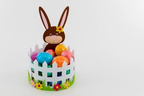 Colorful Easter eggs in a basket with an Easter bunny Stock Photos