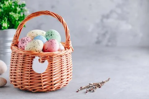 Colorful Easter eggs in the basket on gray stone concrete background Stock Photos