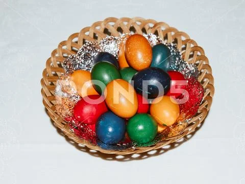 Colorful easter eggs in basket. Happy Easter, Christian religious holiday. Stock Photos