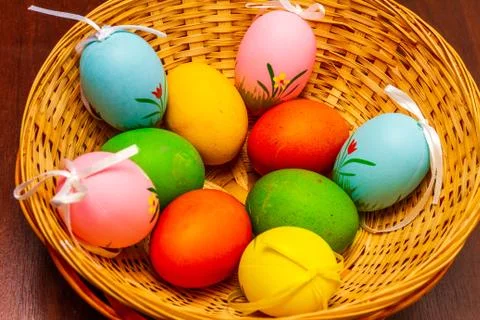 Colorful easter eggs in a basket isolated Stock Photos