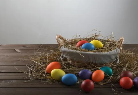 Colorful easter eggs in a basket Stock Photos