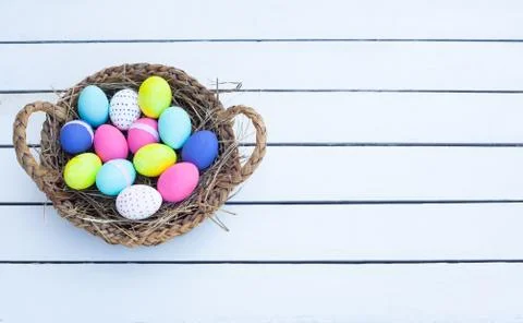 Colorful easter eggs in basket Stock Photos