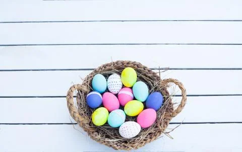 Colorful easter eggs in basket Stock Photos