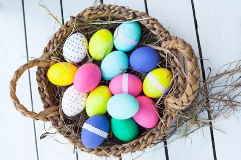 Colorful easter eggs in basket Stock Photos