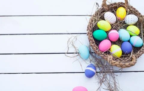Colorful easter eggs in basket Stock Photos