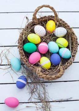 Colorful easter eggs in basket Stock Photos