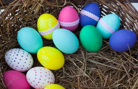 Colorful easter eggs in basket Stock Photos