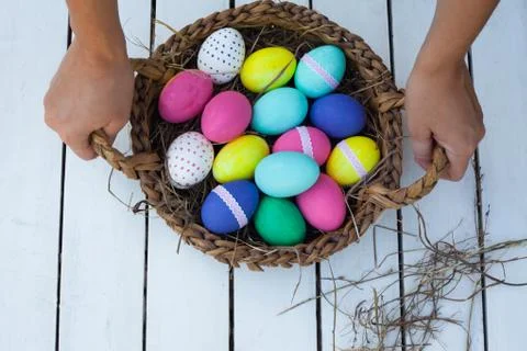 Colorful easter eggs in basket Stock Photos