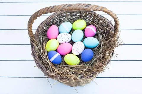 Colorful easter eggs in basket Stock Photos