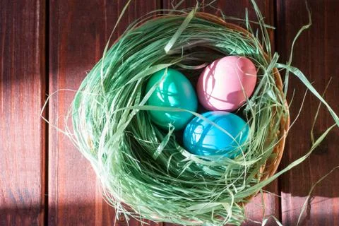 Colorful easter eggs in basket a Stock Photos