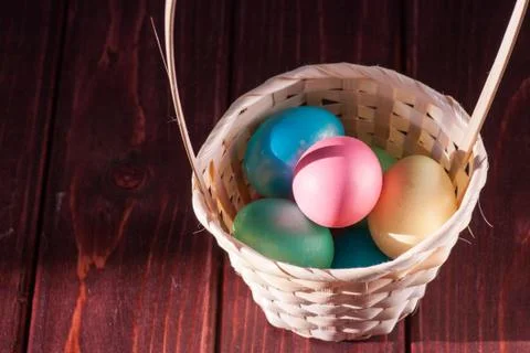 Colorful easter eggs in basket a Stock Photos