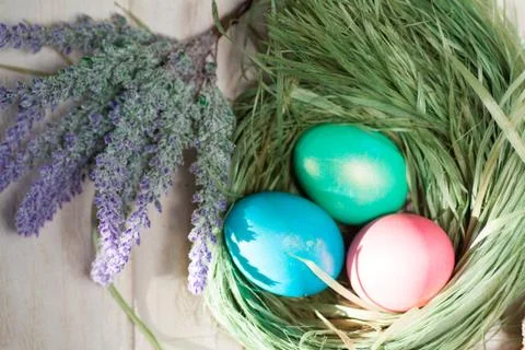Colorful easter eggs in basket a Stock Photos