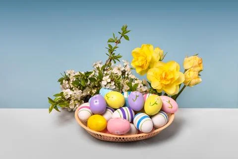 Colorful Easter eggs in basket Stock Photos