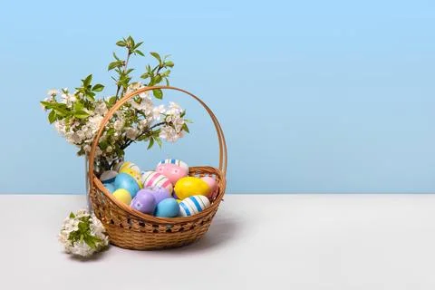 Colorful Easter eggs in basket Stock Photos