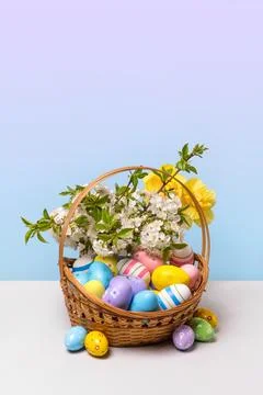 Colorful Easter eggs in basket Stock Photos