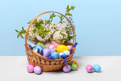 Colorful Easter eggs in basket Stock Photos