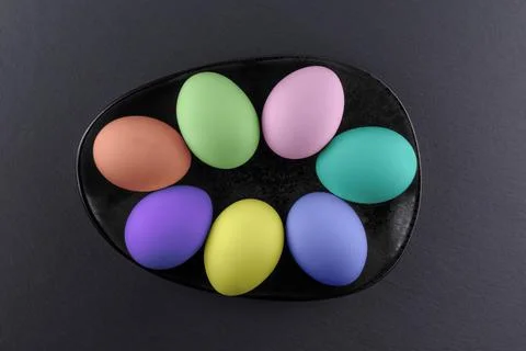 Colorful Easter eggs on a black stone background.Abstract easter concept Stock Photos