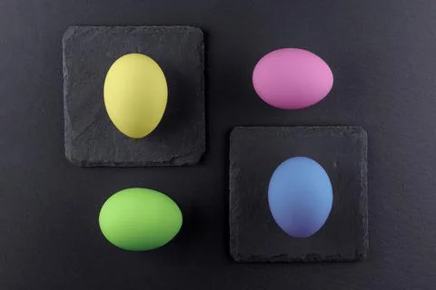 Colorful Easter eggs on a black stone background.Abstract easter concept Stock Photos