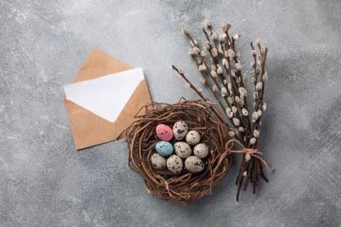 Colorful easter eggs in box and flowers on table. Top view with copy space Stock Photos