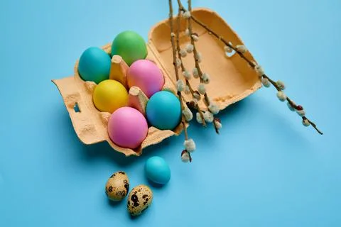 Colorful easter eggs in box on blue background Stock Photos