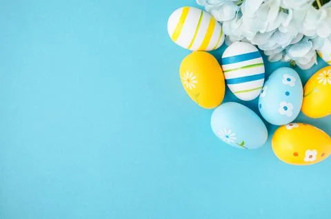 Colorful easter eggs on bright blue background banner. Stock Photos