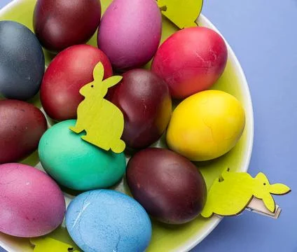 Colorful easter eggs with bunny decorations in a bowl Stock Photos