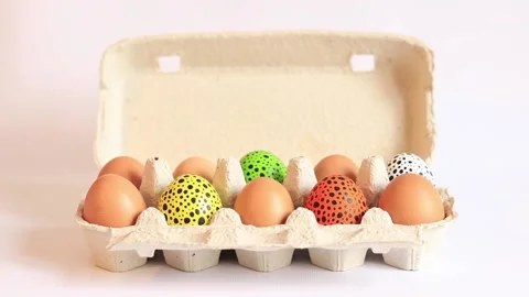 Colorful Easter eggs in a cardboard box on a white background Stock Footage 237820282