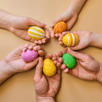 Colorful easter eggs in child hands after egg-hunt Stock Photos