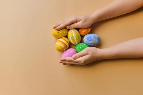 Colorful easter eggs in child hands after egg-hunt Stock Photos