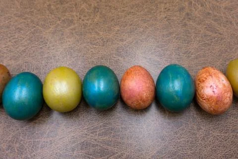 Colorful Easter eggs decoration lying ing line over the brown wooden surface  Stock Photos