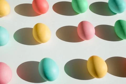 Colorful Easter eggs with deep shadows on a white background. Stock Photos